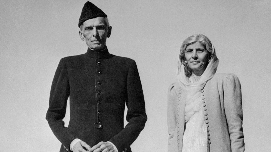 Celebrating his 72nd birthday, Muhammed Ali Jinnah, Governor-General of Pakistan, strolls on the lawn of the Government House in Karachi with his sister, Fatima.
