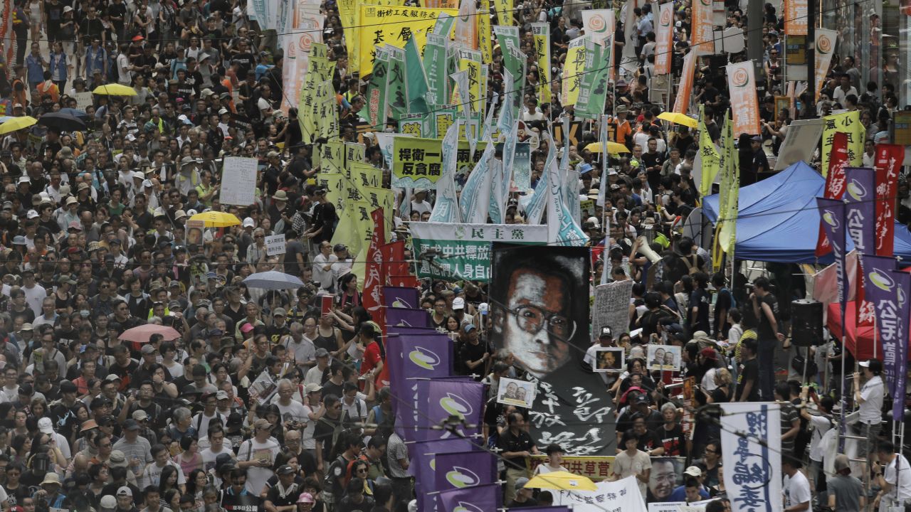 Protesters carry a large image of jailed Chinese Nobel Peace laureate Liu Xiaobo as they march during the annual pro-democracy protest in Hong Kong, Saturday, July 1, 2017. 
