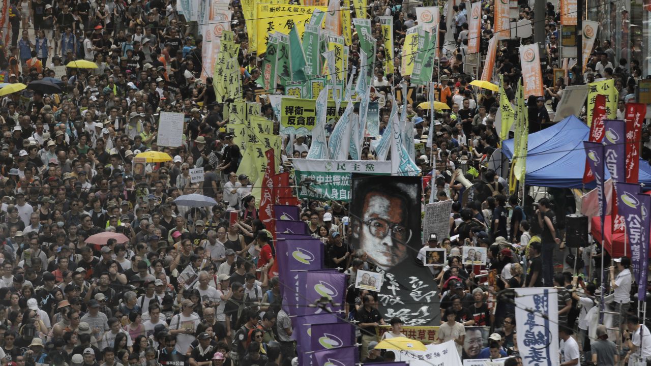Protesters carry a large image of jailed Chinese Nobel Peace laureate Liu Xiaobo as they march during the annual pro-democracy protest in Hong Kong, Saturday, July 1, 2017.