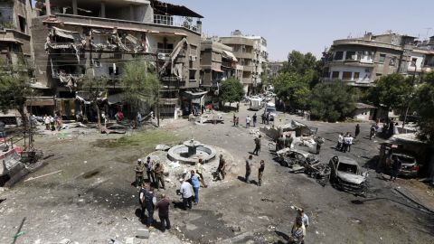 Syrians inspect the site of a suicide bomb attack in the capital's eastern Tahrir Square district on Sunday.