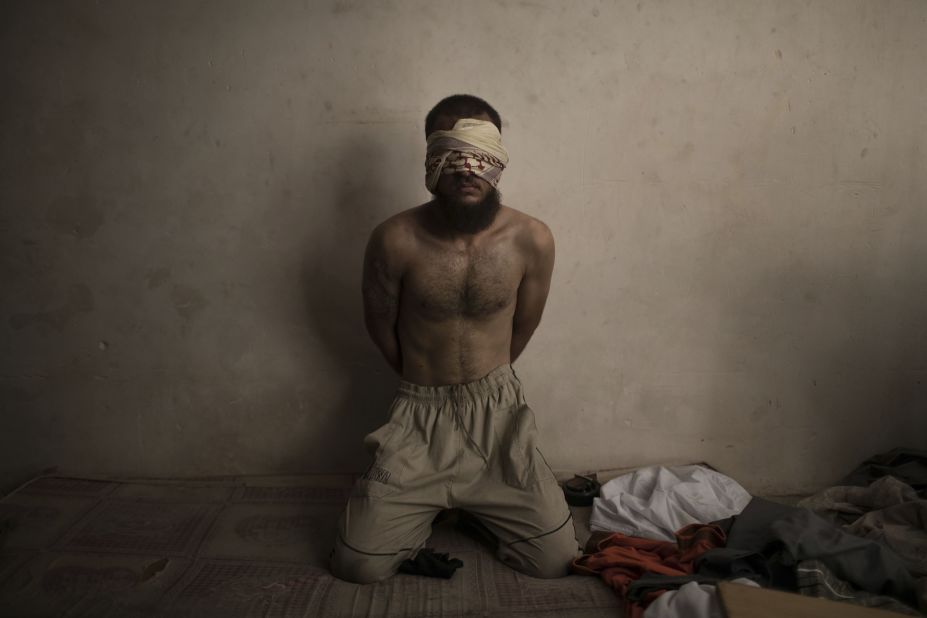 A suspected ISIS fighter is held in a basement while Iraqi forces continue to push for control of the Old City of Mosul on Monday, July 3.