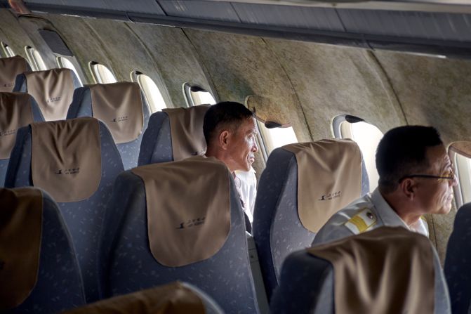 Off-duty Air Koryo crew members take in the view outside. 