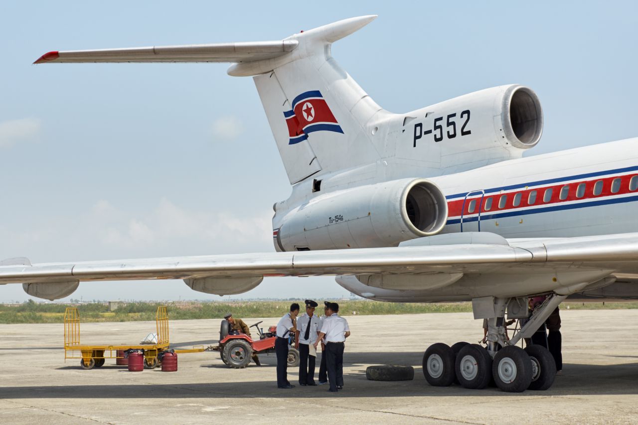Pilots hold a work meeting under the Tupolev-154. Due to international sanctions and environmental restrictions, Air Koryo's fleet consists of several classic Russian jetliners. 