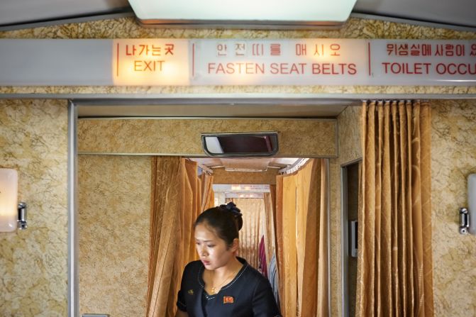 A flight attendant at work in the unique interior of the Tupolev-154.