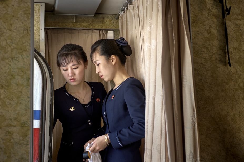 A senior flight attendant explains the door-handling procedure to a colleague.  