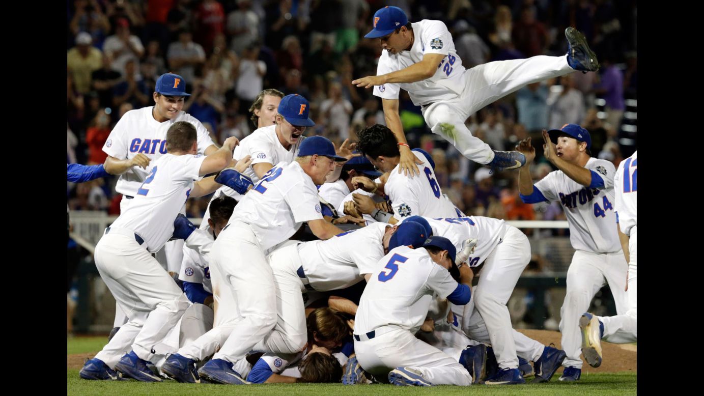 Nick Horvath leaps into the dog pile as Florida's baseball team celebrates a national title on Tuesday, June 27. The Gators defeated LSU in the finals of the College World Series.