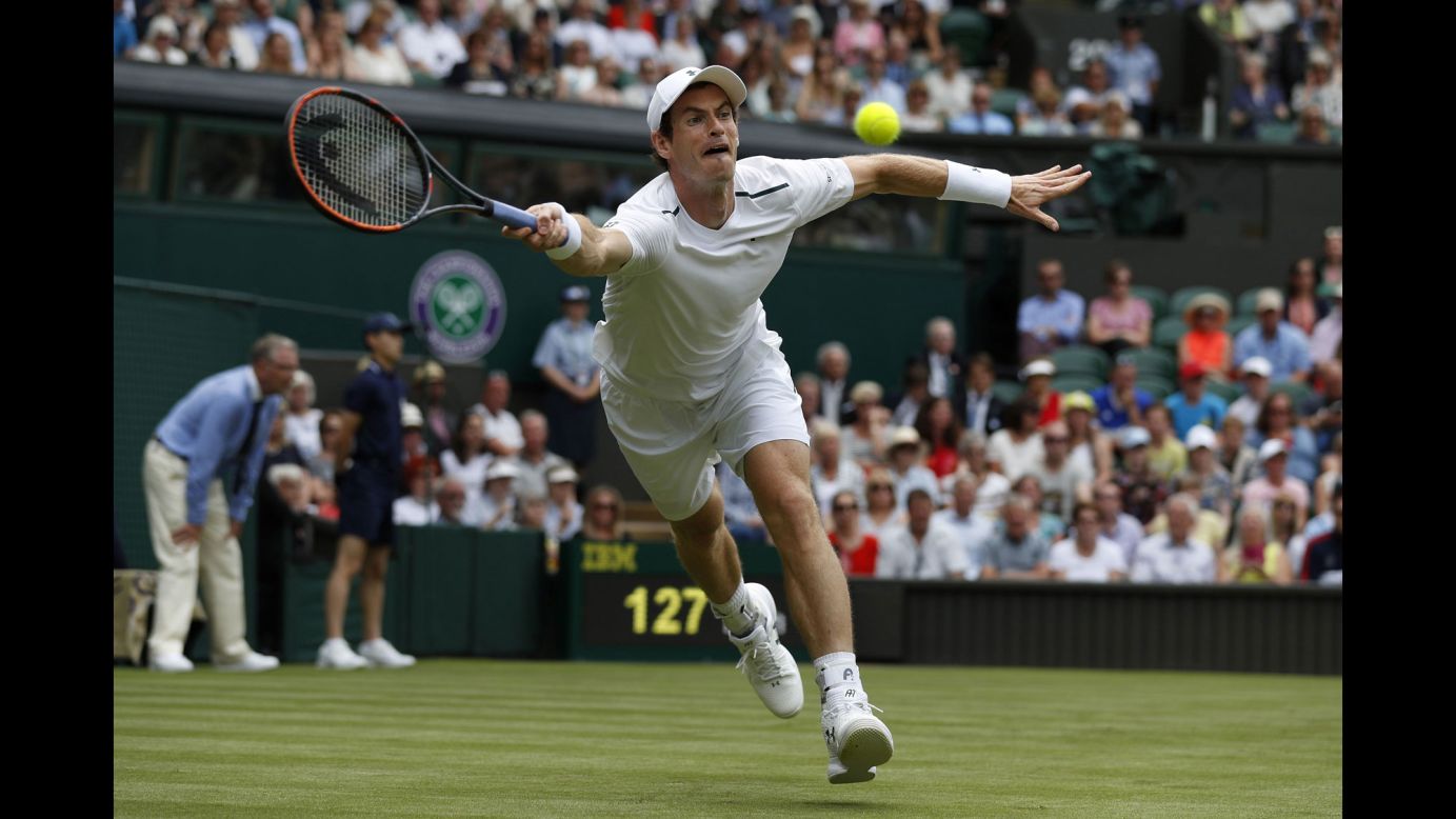 Andy Murray stretches for a return during his first-round match at Wimbledon on Monday, July 3. Murray, the tournament's No. 1 seed and defending champion, advanced in straight sets.