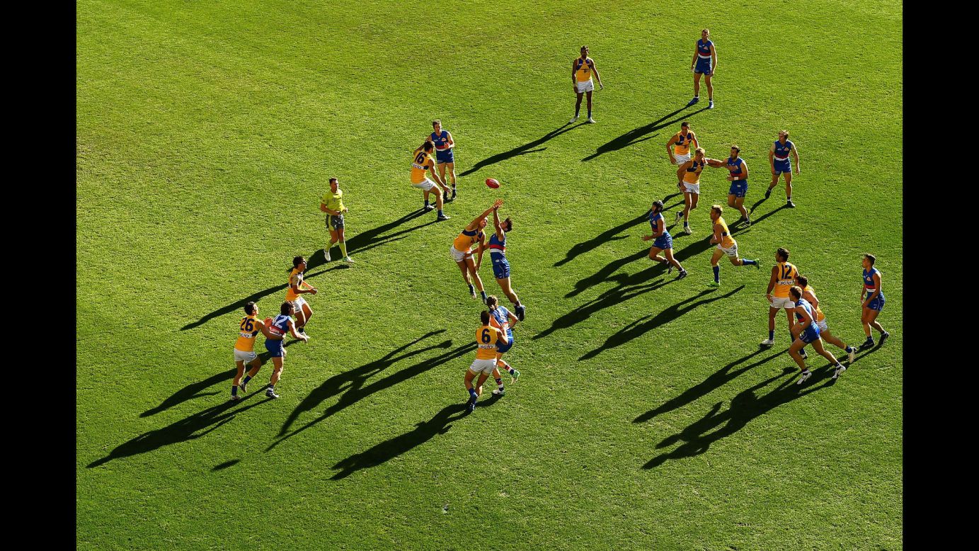 Players from the Western Bulldogs and the West Coast Eagles leap for a ball during an Australian Football League match in Melbourne on Saturday, July 1.