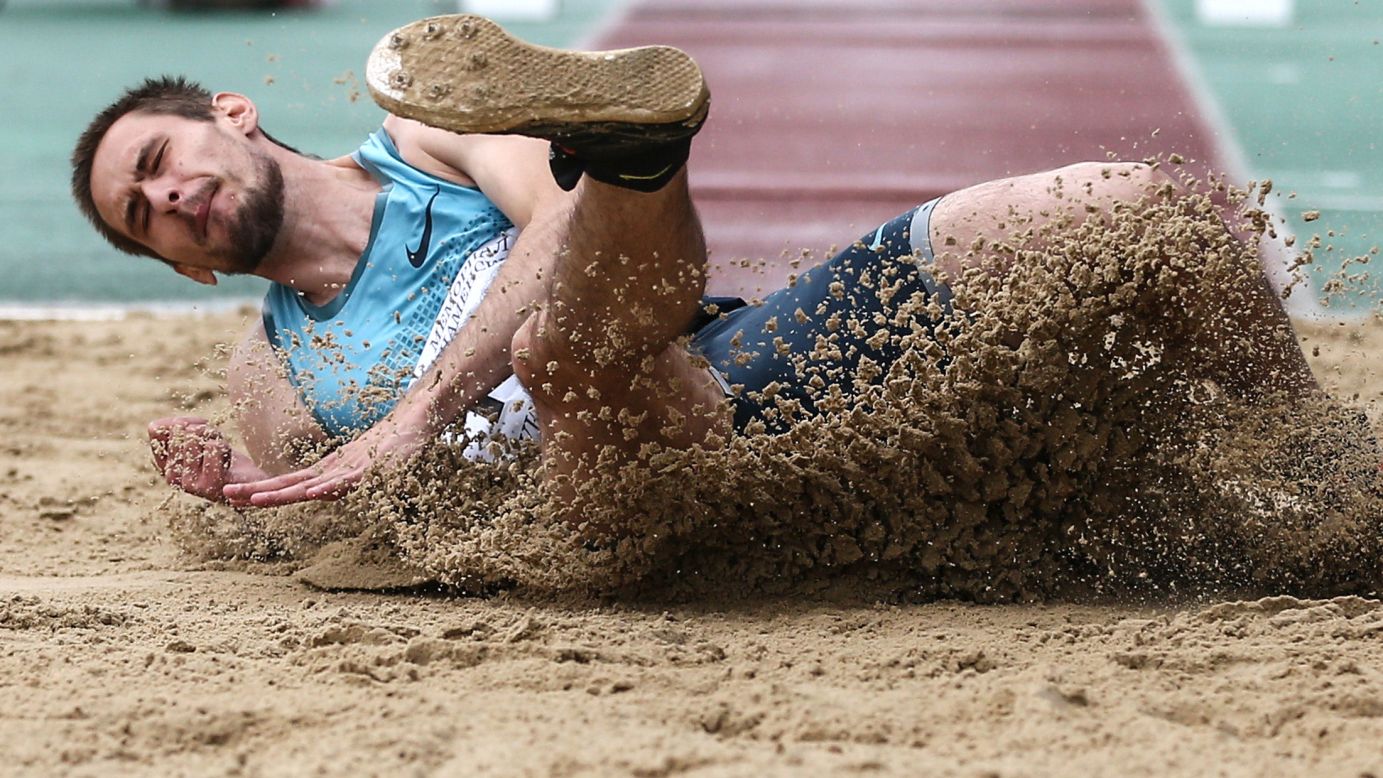 Russian triple jumper Artem Primak lands in the sand pit during a meet in Zhukovsky, Russia, on Sunday, July 2.
