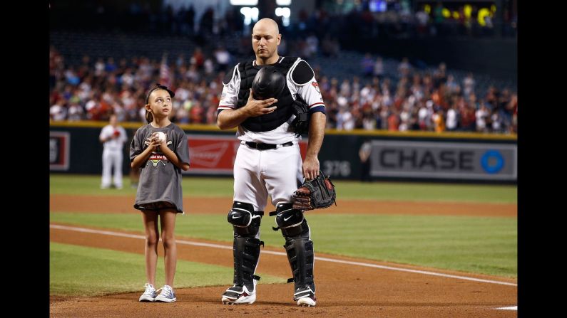 Arizona catcher Chris Iannetta stands with a young fan during the national anthem in Phoenix on Sunday, July 2. <a href="index.php?page=&url=http%3A%2F%2Fwww.cnn.com%2F2017%2F06%2F26%2Fsport%2Fgallery%2Fwhat-a-shot-sports-0627%2Findex.html" target="_blank">See 33 amazing sports photos from last week</a>