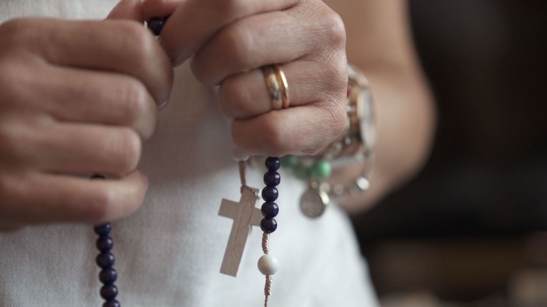 Fatima Alves says she uses her rosary beads three times a day.