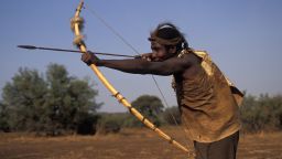 Hadza man hunting with bow and arrow, Lake Eyasi, Tanzania. Small tribe of hunter-gatherers also known as the Hadzabe.