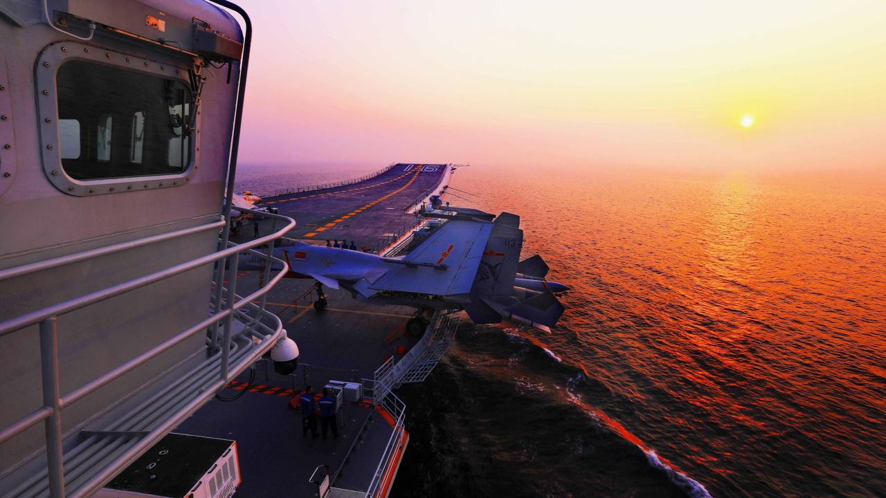 Fighter jets sit on the flight deck of the Liaoning prior to a night training exercise on July 1.