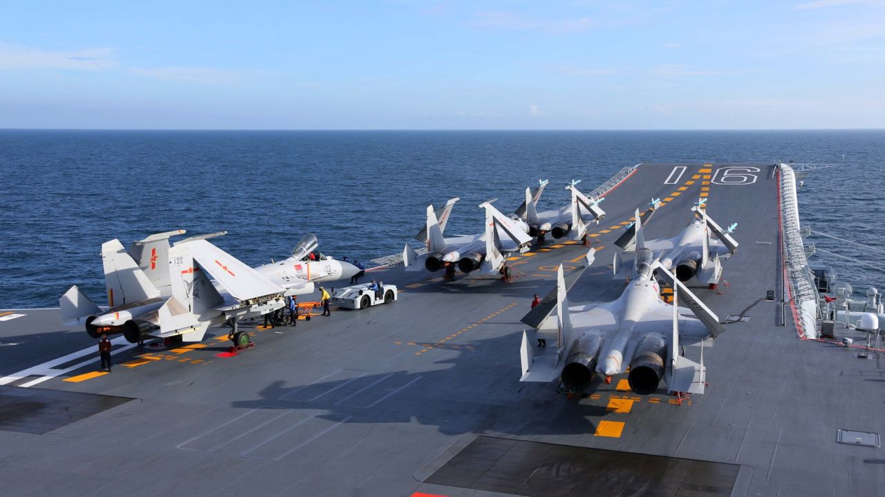 The J-15 fighter jets sit on the flight deck of the aircraft carrier Liaoning prior to a training exercise on July 1.