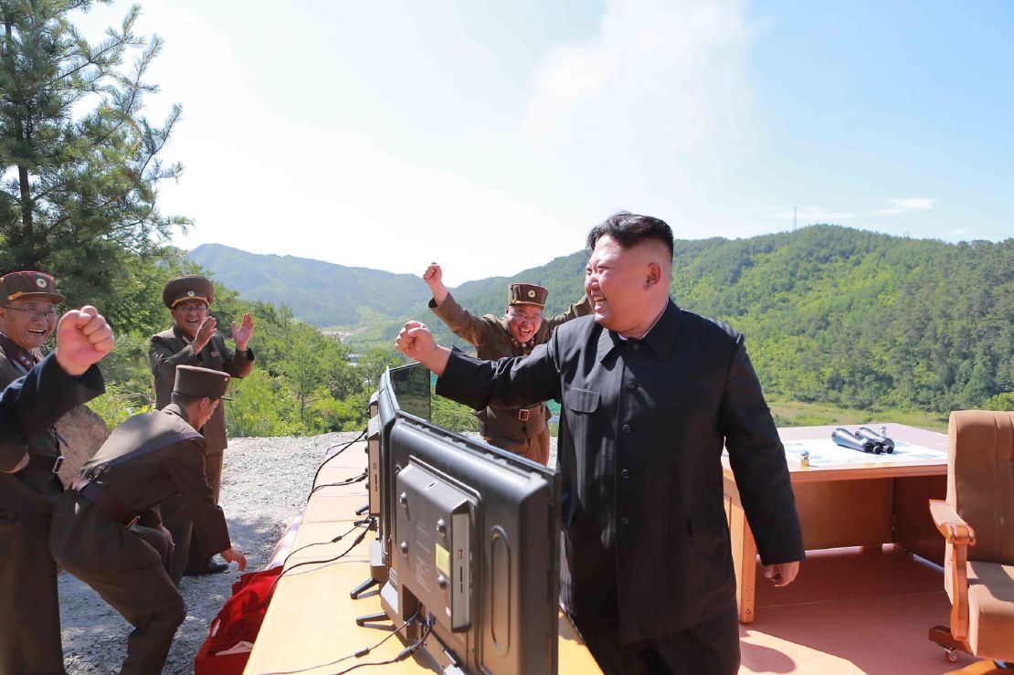 North Korean leader Kim Jong-Un (R) reacting after the test-fire of the intercontinental ballistic missile Hwasong-14 on July 4.
