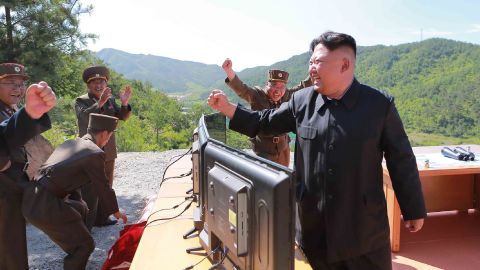 North Korean leader Kim Jong-Un (R) reacting after the test-fire of the intercontinental ballistic missile Hwasong-14 on July 4.