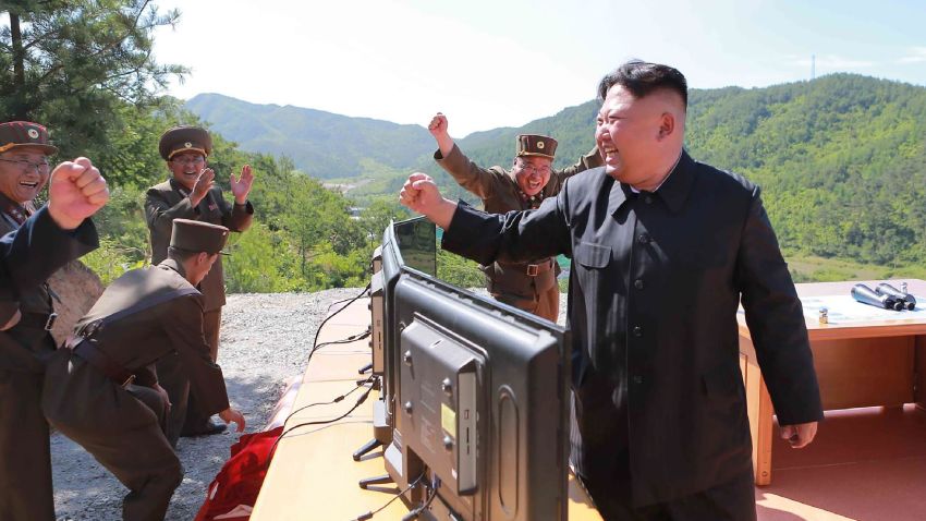 This picture taken and released on July 4, 2017 by North Korea's official Korean Central News Agency (KCNA) shows North Korean leader Kim Jong-Un (R) reacting after the test-fire of the intercontinental ballistic missile Hwasong-14 at an undisclosed location.
North Korea declared on July 4 it had successfully tested its first intercontinental ballistic missile -- a watershed moment in its push to develop a nuclear weapon capable of hitting the mainland United States. / AFP PHOTO / KCNA VIA KNS / STR / South Korea OUT / REPUBLIC OF KOREA OUT   ---EDITORS NOTE--- RESTRICTED TO EDITORIAL USE - MANDATORY CREDIT "AFP PHOTO/KCNA VIA KNS" - NO MARKETING NO ADVERTISING CAMPAIGNS - DISTRIBUTED AS A SERVICE TO CLIENTS
THIS PICTURE WAS MADE AVAILABLE BY A THIRD PARTY. AFP CAN NOT INDEPENDENTLY VERIFY THE AUTHENTICITY, LOCATION, DATE AND CONTENT OF THIS IMAGE. THIS PHOTO IS DISTRIBUTED EXACTLY AS RECEIVED BY AFP. 
 / STR/AFP/Getty Images