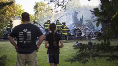 Mike Tingley and his daughter watch firefighters put out his garage fire Monday evening.