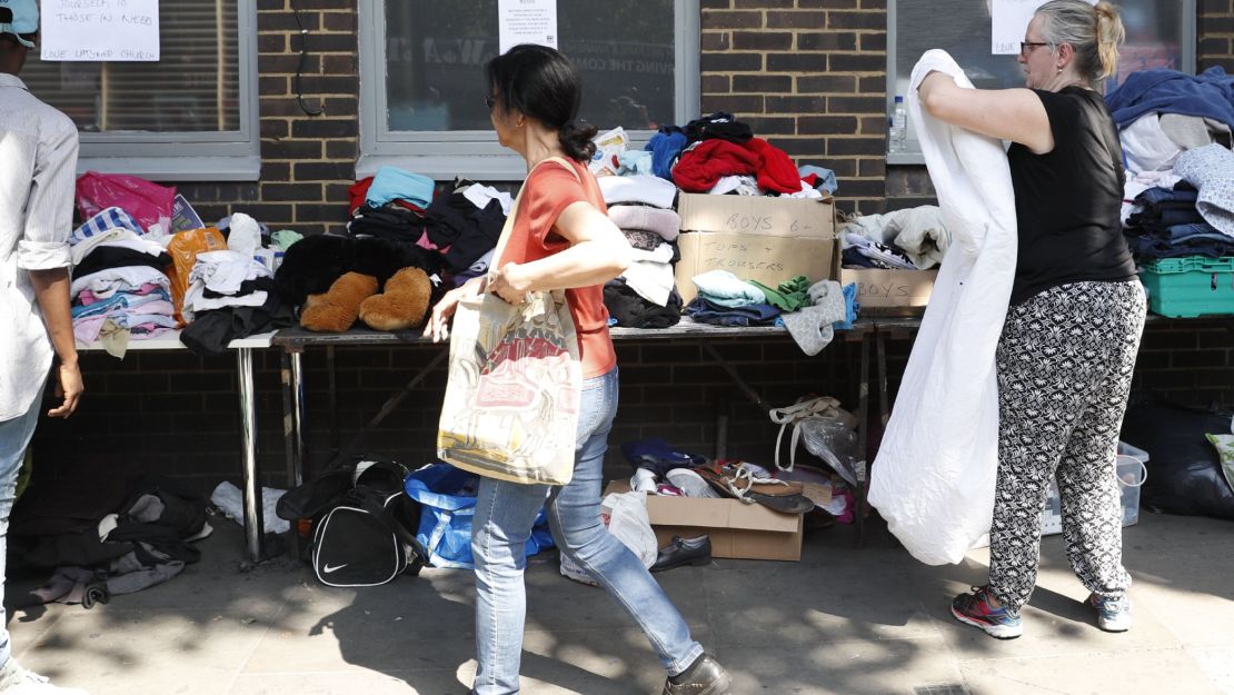 Clothes are offered to those affected by the fire that ripped through Grenfell Tower, a residential block in west London on June 14.