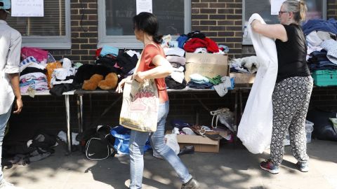 Clothes are offered to those affected by the fire that ripped through Grenfell Tower, a residential block in west London on June 14. 