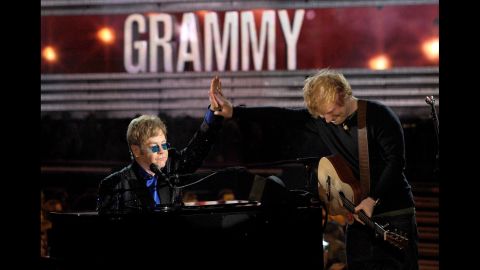 John performs with Ed Sheeran at the 2013 Grammy Awards. They teamed up for Sheeran's song "The A Team."
