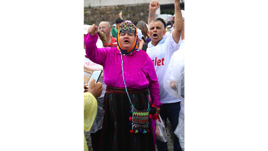A woman in traditional Aegean clothes participates in the Justice March.