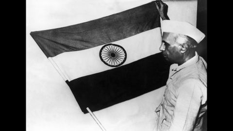 Nehru, then-vice president of the Indian National Congress party, presents the national flag of the nation during a meeting of the constituent assembly in July 1947.