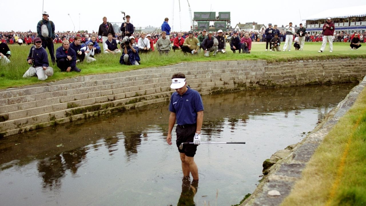 Frenchman Jean Van de Velde looks at his ball in the burn on the 18th hole during the 1999 British Open at Carnoustie.