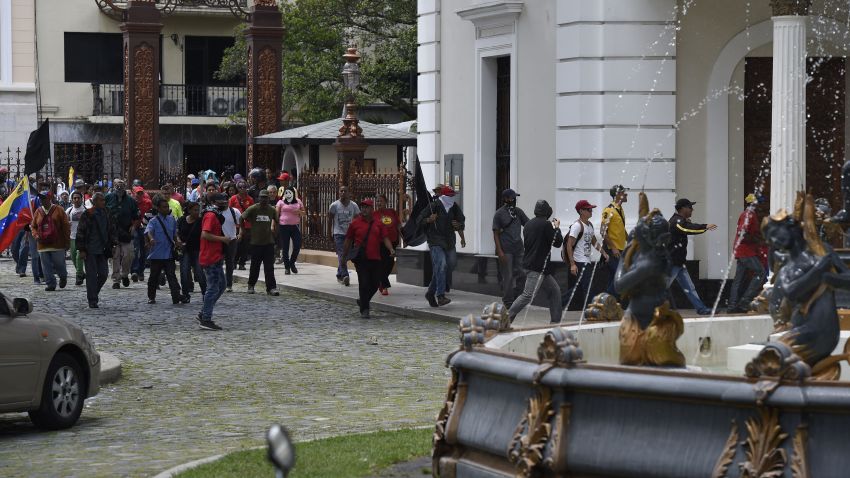 Supporters of Venezuelan President Nicolas Maduro storm the National Assembly building in Caracas on July 5, 2017 as opposition deputies hold a special session on Independence Day.
A political and economic crisis in the oil-producing country has spawned often violent demonstrations by protesters demanding President Nicolas Maduro's resignation and new elections. The unrest has left 91 people dead since April 1. / AFP PHOTO / Juan BARRETO        (Photo credit should read JUAN BARRETO/AFP/Getty Images)