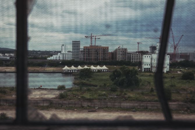 Through metal mesh the new development of Silvertown begins. Plans include some 3,385 new residential units and a home for 150 businesses 
