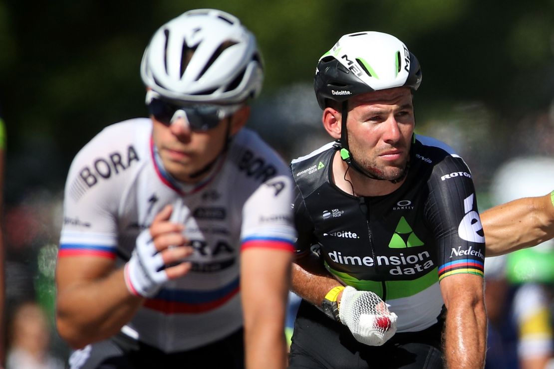 Cavendish (right) crosses the finish line after the crash.