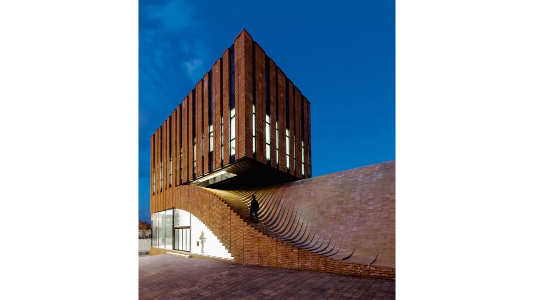This red-brick office building is patterned with traditional brick layering techniques to respect local context. 