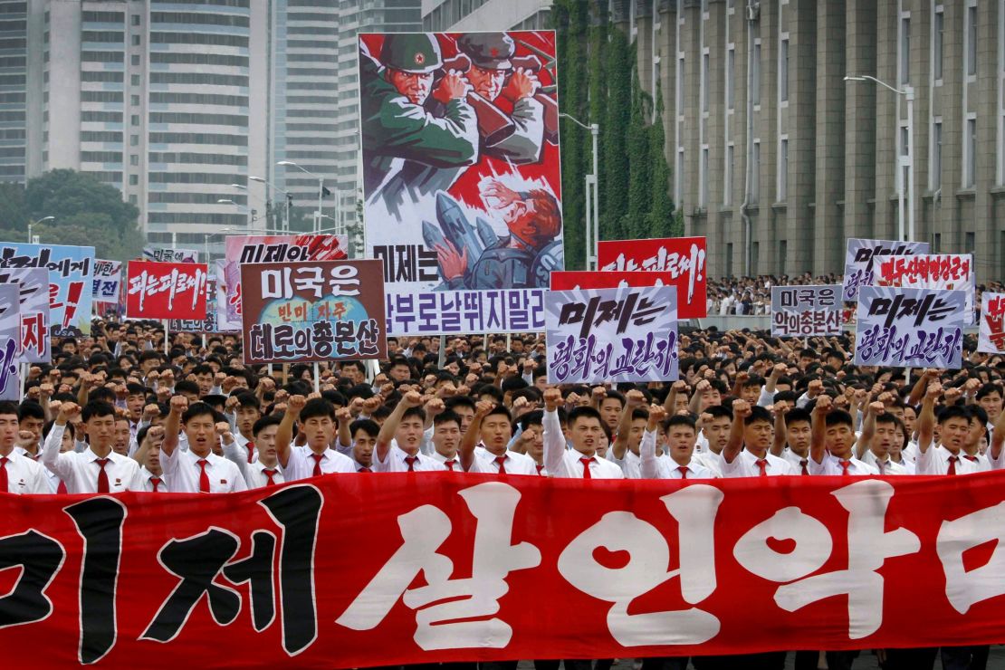 Tens of thousands of men and women pump their fists in the air and chant "Defend!" as they carry placards with anti-American propaganda slogans at Pyongyang's central Kim Il Sung Square Sunday, June 25, 2017, in Pyongyang, North Korea -- the anniversary of the start of the Korean War. In North Korea, it's called "the day of struggle against US imperialism."