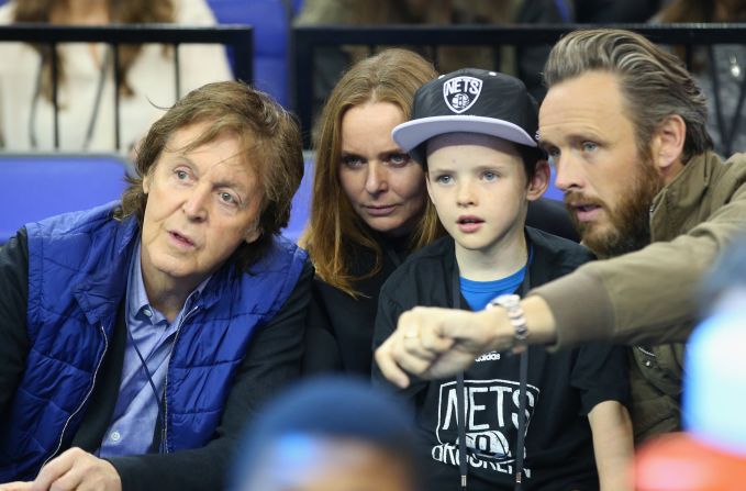McCartney shares some time out with her Beatle dad, Paul (left) and husband Alasdhair (right) at London's O2 arena during an NBA match between Brooklyn Nets and Atlanta Hawks in 2014. 