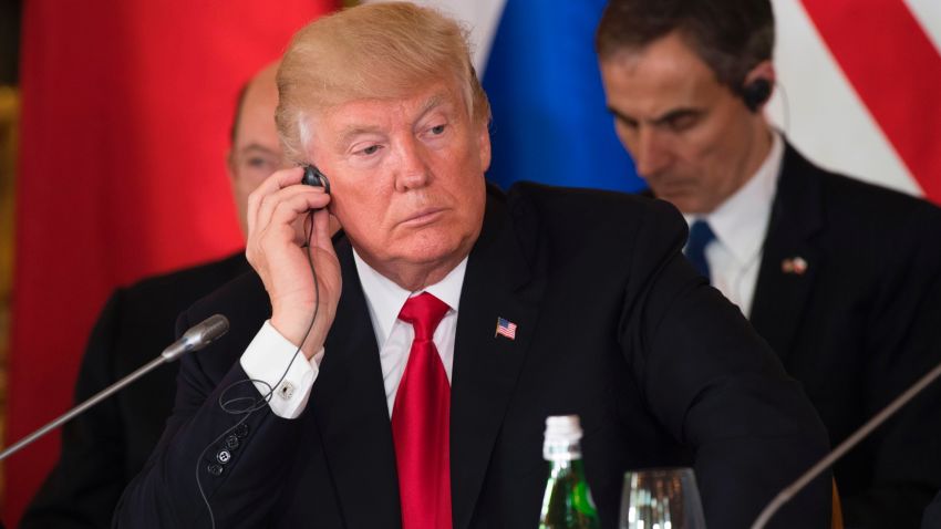 US President Donald Trump adjusts his headphones during the Three Seas Initiative Summit of Eastern European countries at the Royal Castle in Warsaw, Poland, July 6, 2017. / AFP PHOTO / SAUL LOEB        (Photo credit should read SAUL LOEB/AFP/Getty Images)