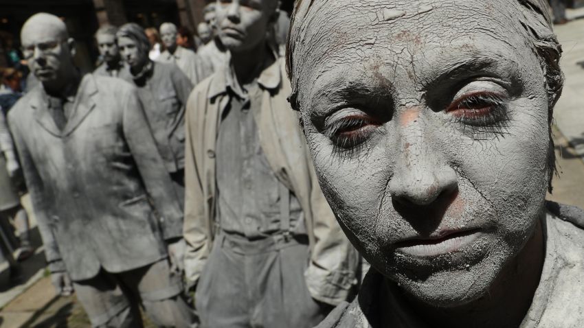 HAMBURG, GERMANY - JULY 05:  Performance artists covered in clay to look like zombies walk trance-like through the city center during a preliminary performance on July 5, 2017 in Hamburg, Germany. In a two-hour show hundreds of actors took part in a creative public appeal for more humanity and self-responsibility ahead of the upcoming G20 summit. The G20 economic summit takes place in Hamburg July 7-8.  (Photo by Sean Gallup/Getty Images)