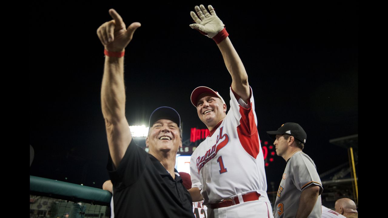 Scalise and US Rep. Lynn Westmoreland wave to fans during the congressional baseball game in June 2014. <a href="http://www.cnn.com/2017/06/14/politics/who-is-steve-scalise/index.html" target="_blank">Scalise is an avid baseball fan</a> who has played in the annual charity game since entering Congress.