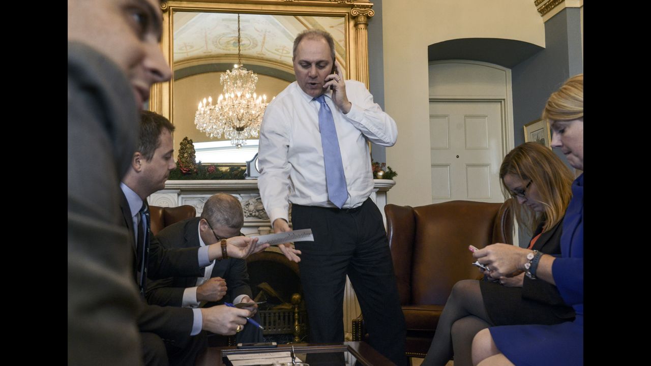 Scalise meets with staff members while checking a vote count in Washington in December 2014. <a href="http://www.cnn.com/2017/06/14/politics/who-is-steve-scalise/index.html" target="_blank">As House majority whip,</a> Scalise is tasked with tracking other Republican members and ensuring there are enough votes to win approval of key priorities.