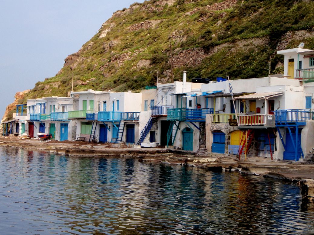 <strong>Klima:</strong> This a picturesque village overlooks Adamantas bay. Traditionally, the colored doors would house the fishing boat and the family would live upstairs. 