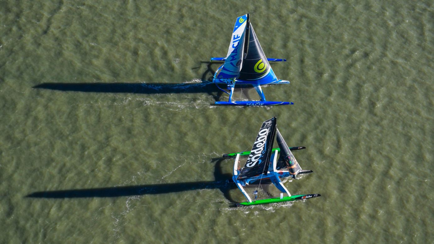 Sodebo (bottom,) the trimaran led by French skipper Thomas Coville, and Macif, captained by Francois Gabart, pictured on the start line.