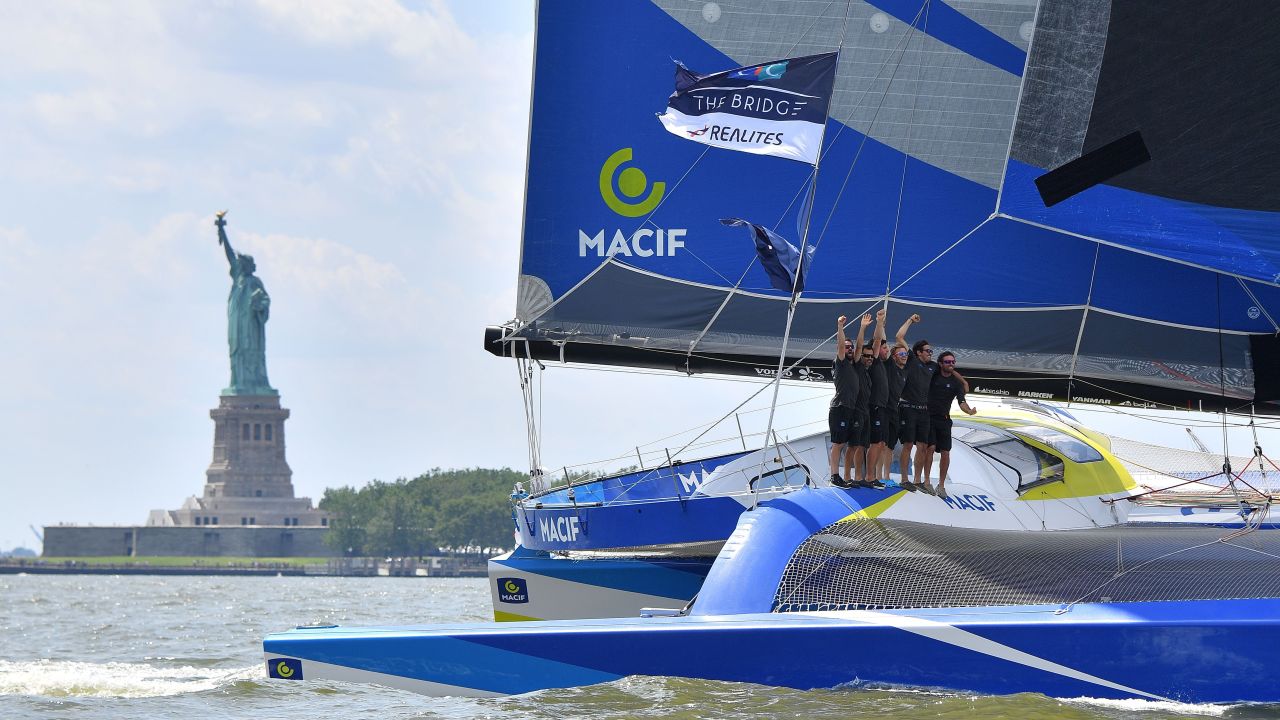 Gabart (C) celebrates with teammates on board Macif after passing under the Verrazano-Narrows Bridge finish line in New York. Macif completed the journey in eight days, 31 minutes and 20 seconds, sailing at an average speed of 18.61 knots. 