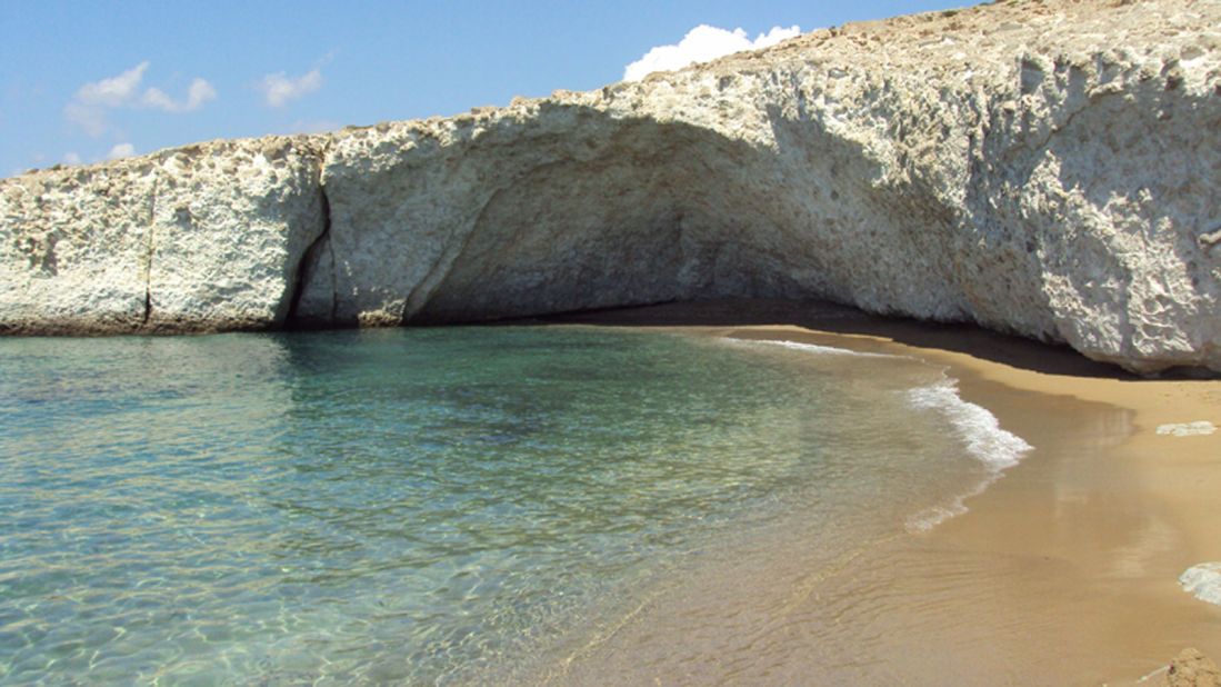 <strong>Alogomantra: </strong>The vaulted ceiling of a half cave hovers over the perfect sands of Alogomantra beach on Milos' north coast.