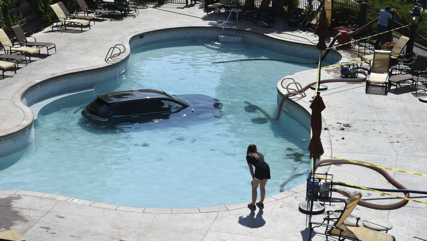 A 73-year-old woman escaped serious injury when she apparently mistook her gas pedal for the brake and drove her vehicle into this swimming pool in Colorado Springs, Colorado, on Monday, July 3. The pool was drained so the vehicle could be towed.