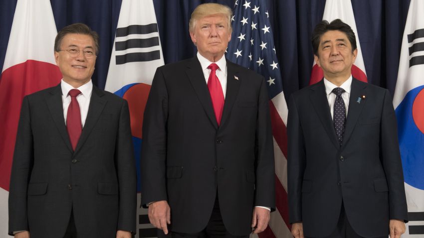 US President Donald Trump (C), Japanese Prime Minister Shinzo Abe (R) and South Korean President Moon Jae-in pose for photos before attending the Northeast Asia Security Dinner at the US Consulate General Hamburg on the sidelines of the G20 Summit in Hamburg, Germany, July 6, 2017. (SAUL LOEB/AFP/Getty Images)