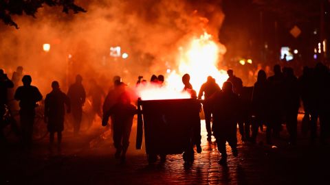 Protesters set fire to items in the street near the Rote Flora left-wing center.