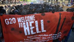 HAMBURG, GERMANY - JULY 06:  Protesters  dressed in all black hold up a banner as they take part in the "Welcome to Hell" protest march on July 6, 2017 in Hamburg, Germany.  Leaders of the G20 group of nations are arriving in Hamburg today for the July 7-8 economic summit and authorities are bracing for large-scale and disruptive protest efforts tonight at the "Welcome to Hell" anti-G20 protest.  (Photo by Leon Neal/Getty Images)