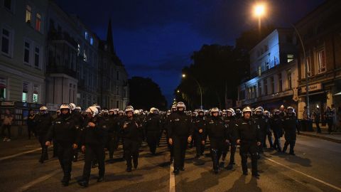 Riot police head down a road during the "Welcome to Hell" protest march on Thursday, July 6. 