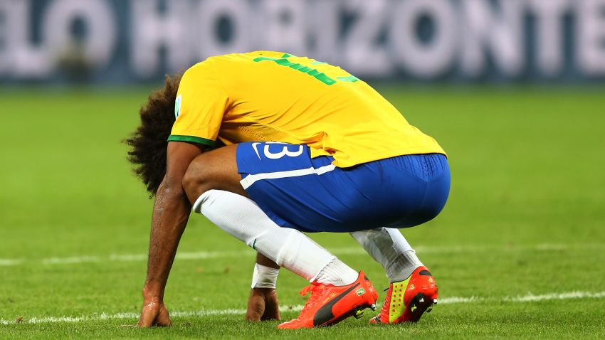 BELO HORIZONTE, BRAZIL - JULY 08:  A dejected Dante  of Brazil reacts after being defeated by Germany 7-1 during the 2014 FIFA World Cup Brazil Semi Final match between Brazil and Germany at Estadio Mineirao on July 8, 2014 in Belo Horizonte, Brazil.  (Photo by Martin Rose/Getty Images)