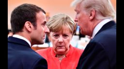 (L-R) French President Emmanuel Macron, German Chancellor Angela Merkel and US President Donald Trump confer at the start of the first working session of the G20 meeting in Hamburg, northern Germany, on July 7.
Leaders of the world's top economies will gather from July 7 to 8, 2017 in Germany for likely the stormiest G20 summit in years, with disagreements ranging from wars to climate change and global trade. / AFP PHOTO / AFP PHOTO AND POOL / John MACDOUGALL        (Photo credit should read JOHN MACDOUGALL/AFP/Getty Images)