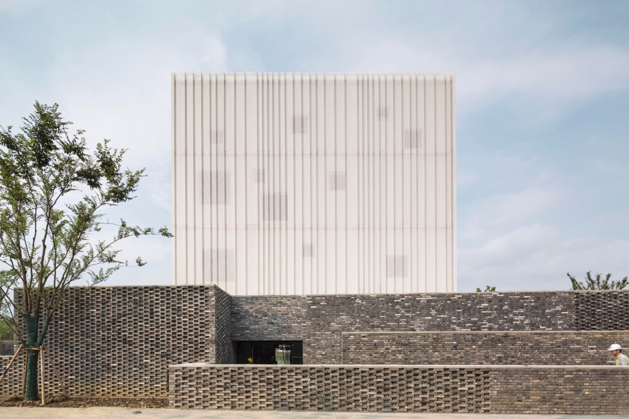 This chapel in Suzhou, China features a perforated metal facade, and uses multiple windows throughout the space to best utilize natural light. 